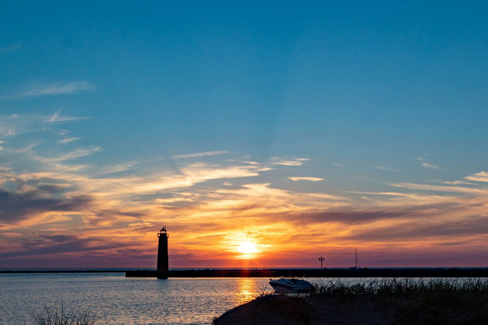 Sunset over Lake Michigan at Muskegon, with a pier lighthouse