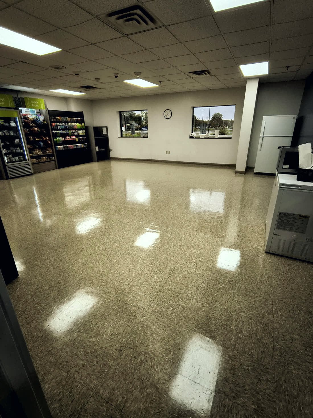 A break room floor finished by Riley's, with the ceiling lights reflected in it